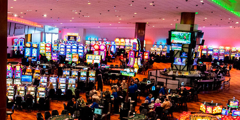 Casino hall with slot machines and visitors